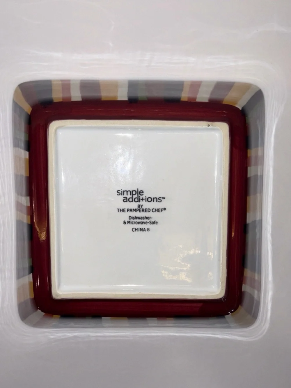 The Pampered Chef Square Ceramic Dish with Red and Multicolor Stripe Trim