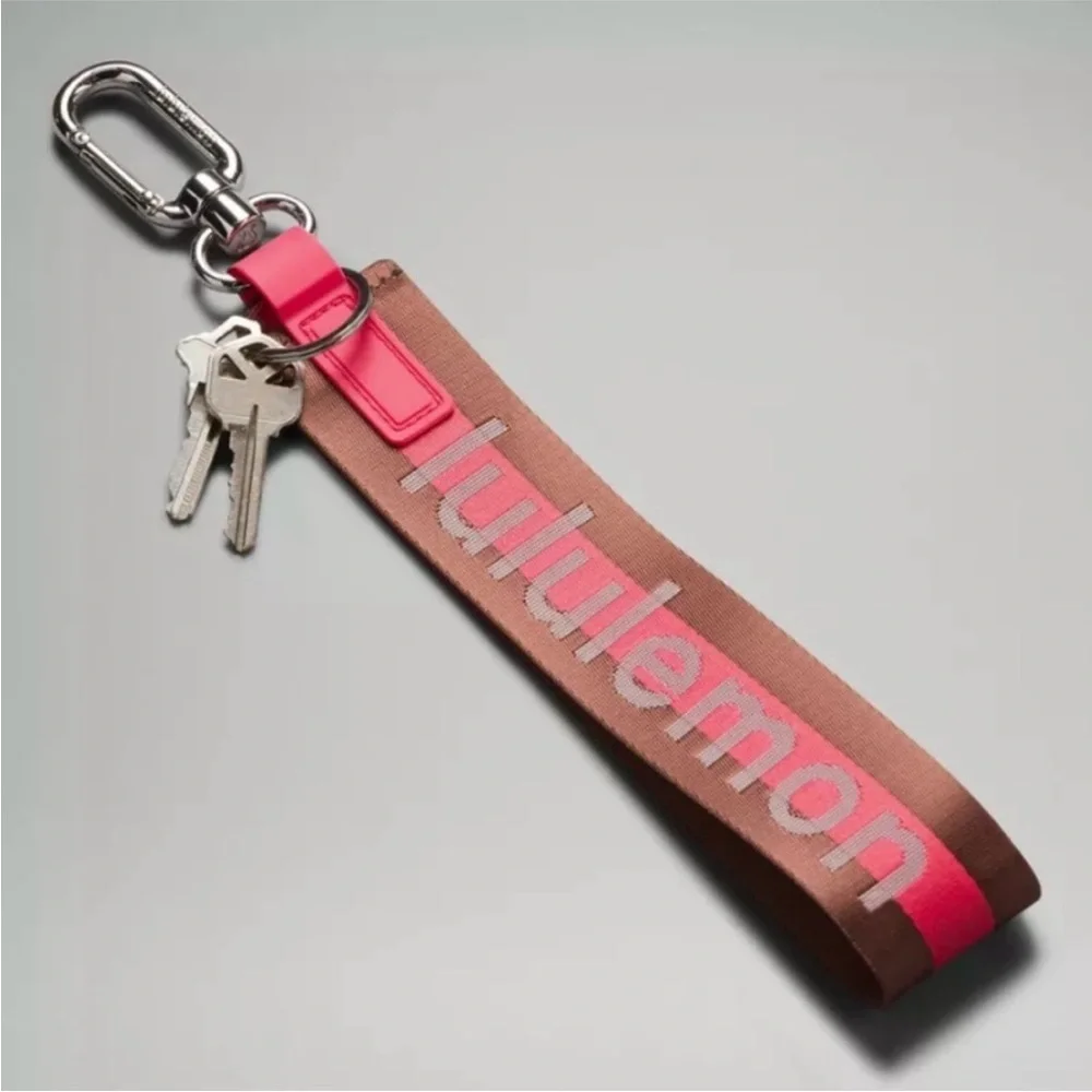 Lululemon Pink and Brown Never lost Word mark Keychain NWOT