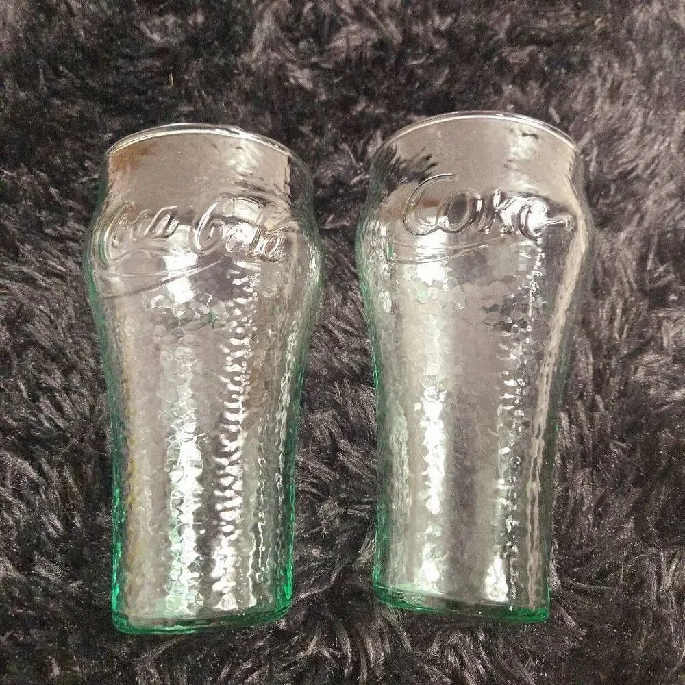 2 vintage Coca-Cola glasses with a green tint and a textured surface, often call