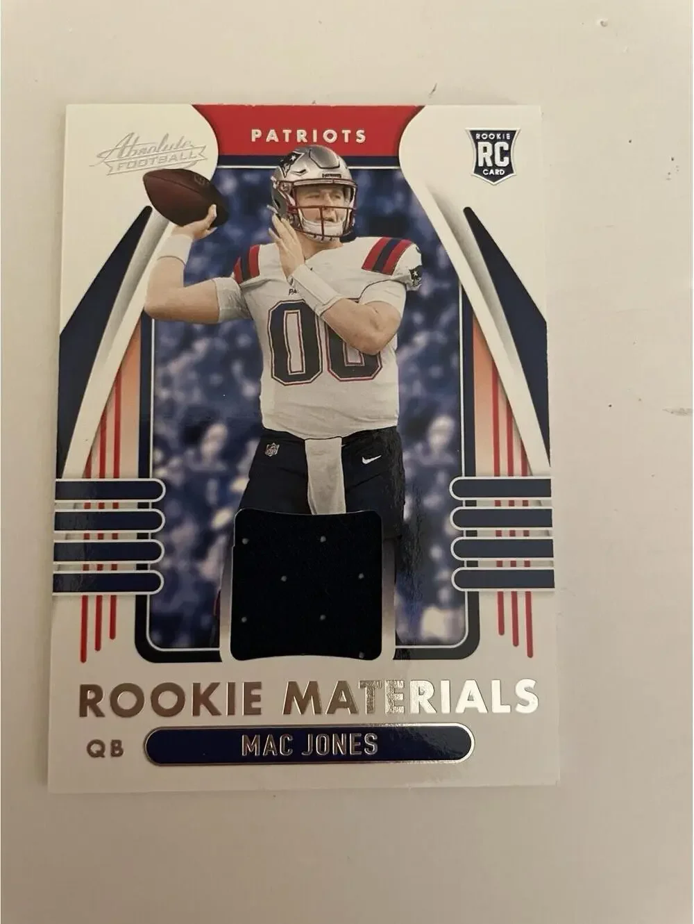 2021 Absolute Football Mac Jones Rookie Materials Patch #ARM-MJO Football Card