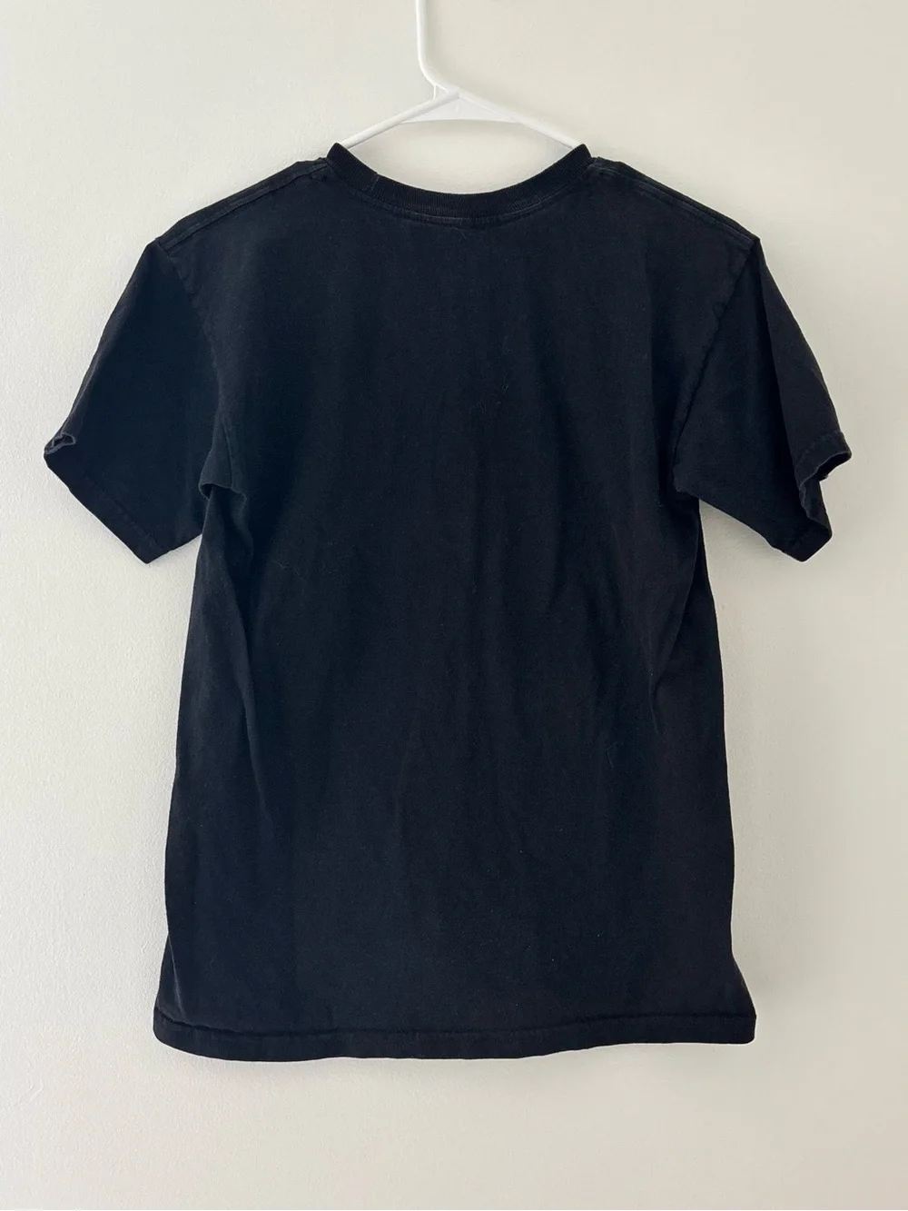Adidas black t-shirt with white Adidas logo on camouflage background