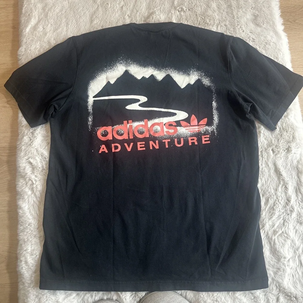 Adidas Adventure men's black graphic t-shirt‎ with Trefoil logo on chest.Size M