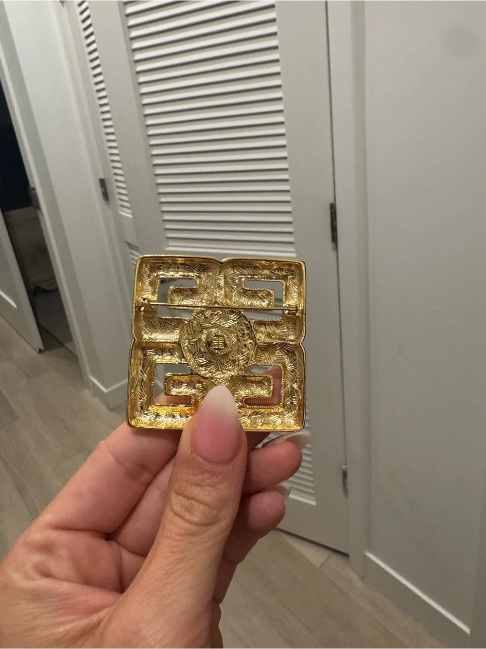 Givenchy brooch prominent