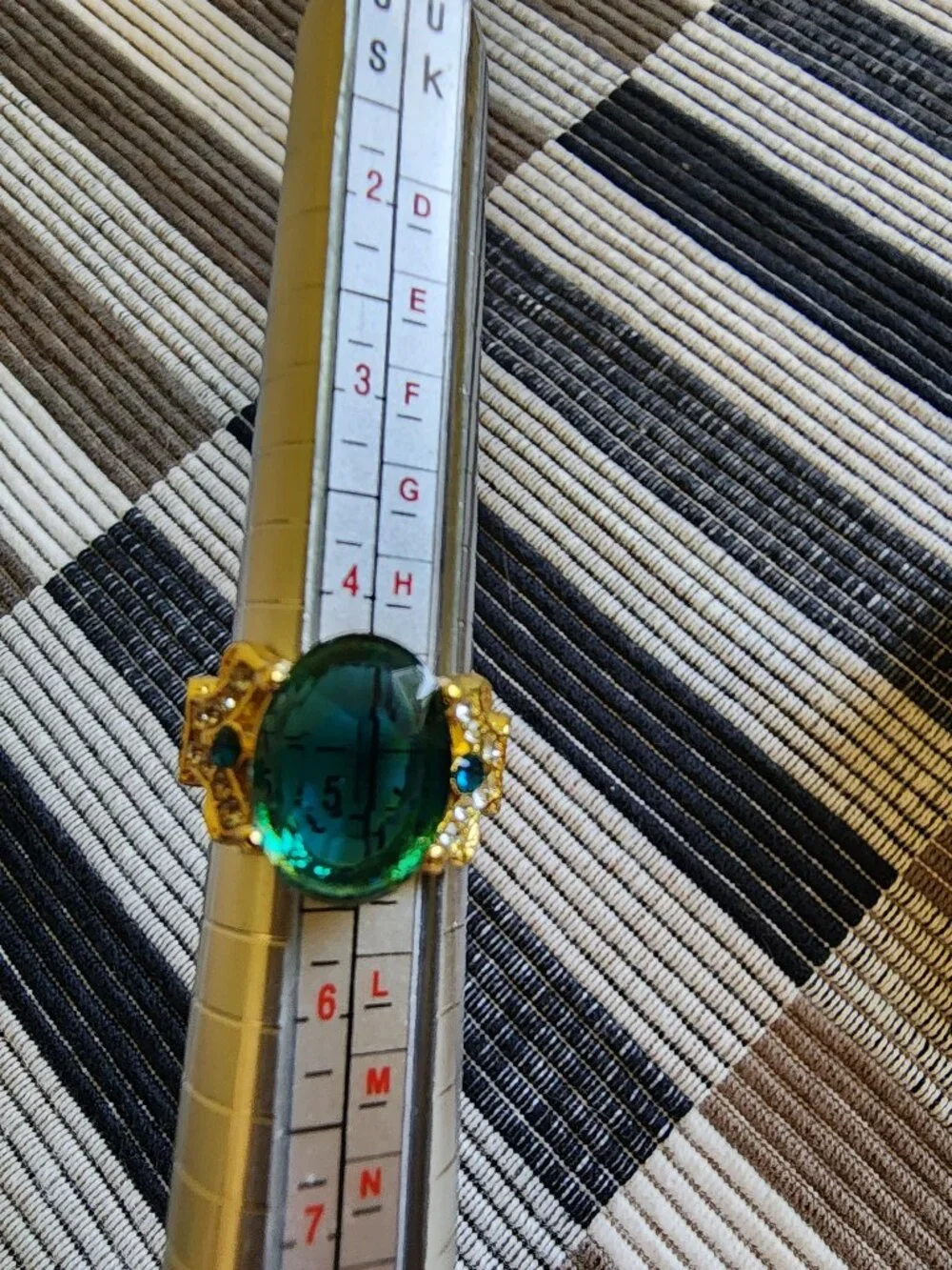 Aqua colored stone in gold colored band. Size 5.