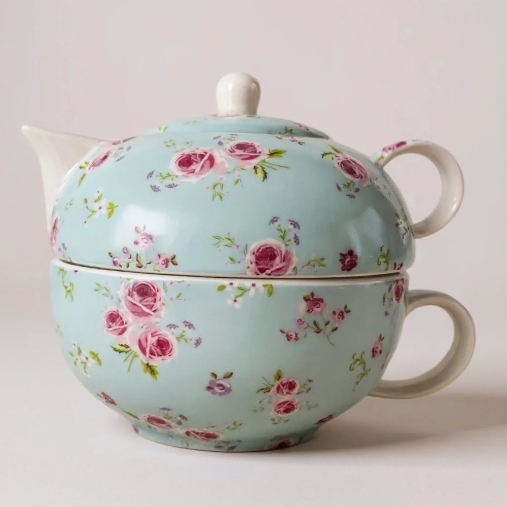 Small teapot with it’s own cup, charming, blue with roses, no flaws