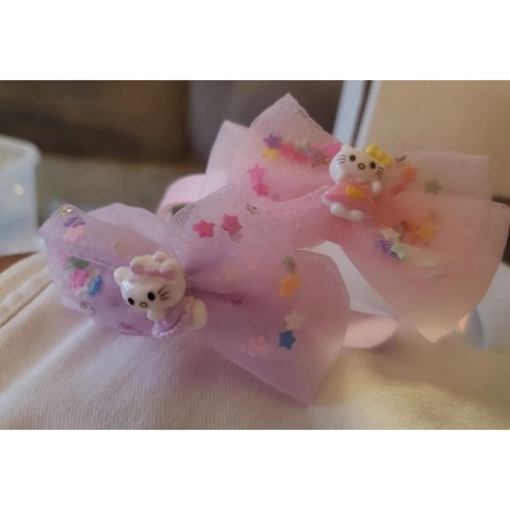 Four Hello Kitty headbands with small figurine