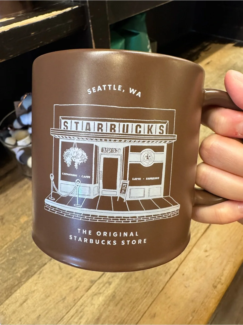 First Starbucks Brown Ceramic Mug with White Storefront Design