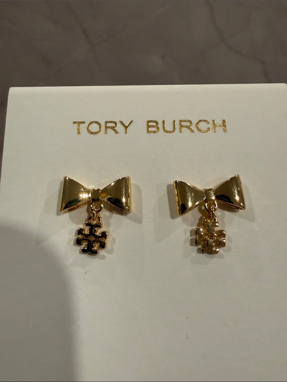 Tory Burch | Shiny Gold Plated Bow Drop Earrings with Logo Charm