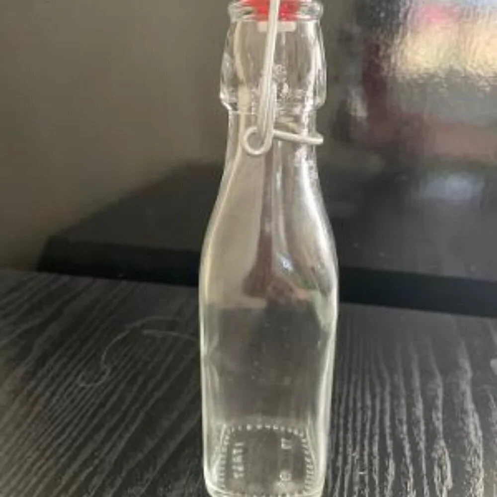 Eight Ounce Clear Bottle With Swing Lid. Italy