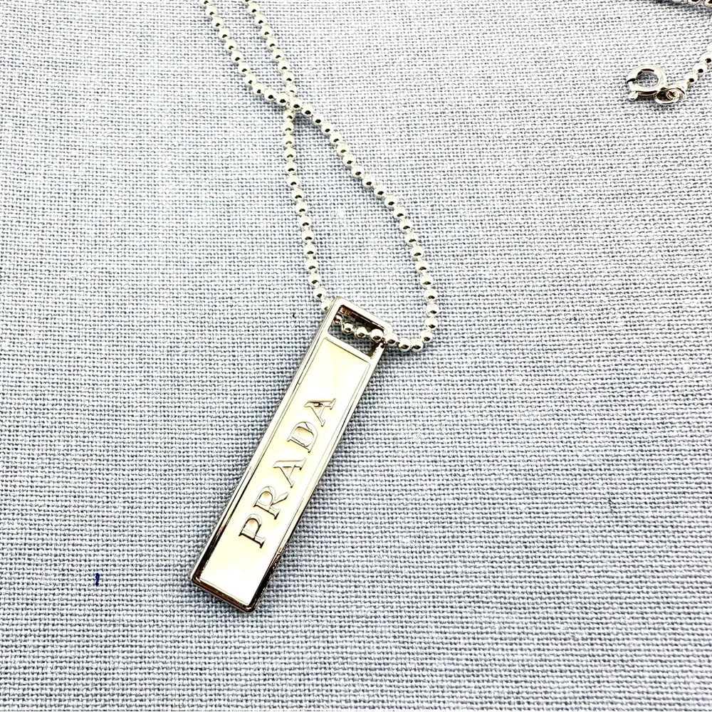 Prada charm w/bonus gift. AUTHENTIC White and silver.