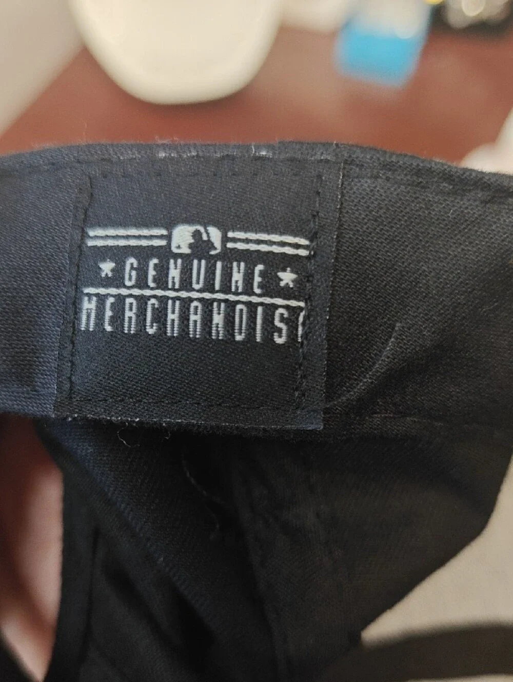Genuine Merchandise Black Baseball Cap with White Logo Tag