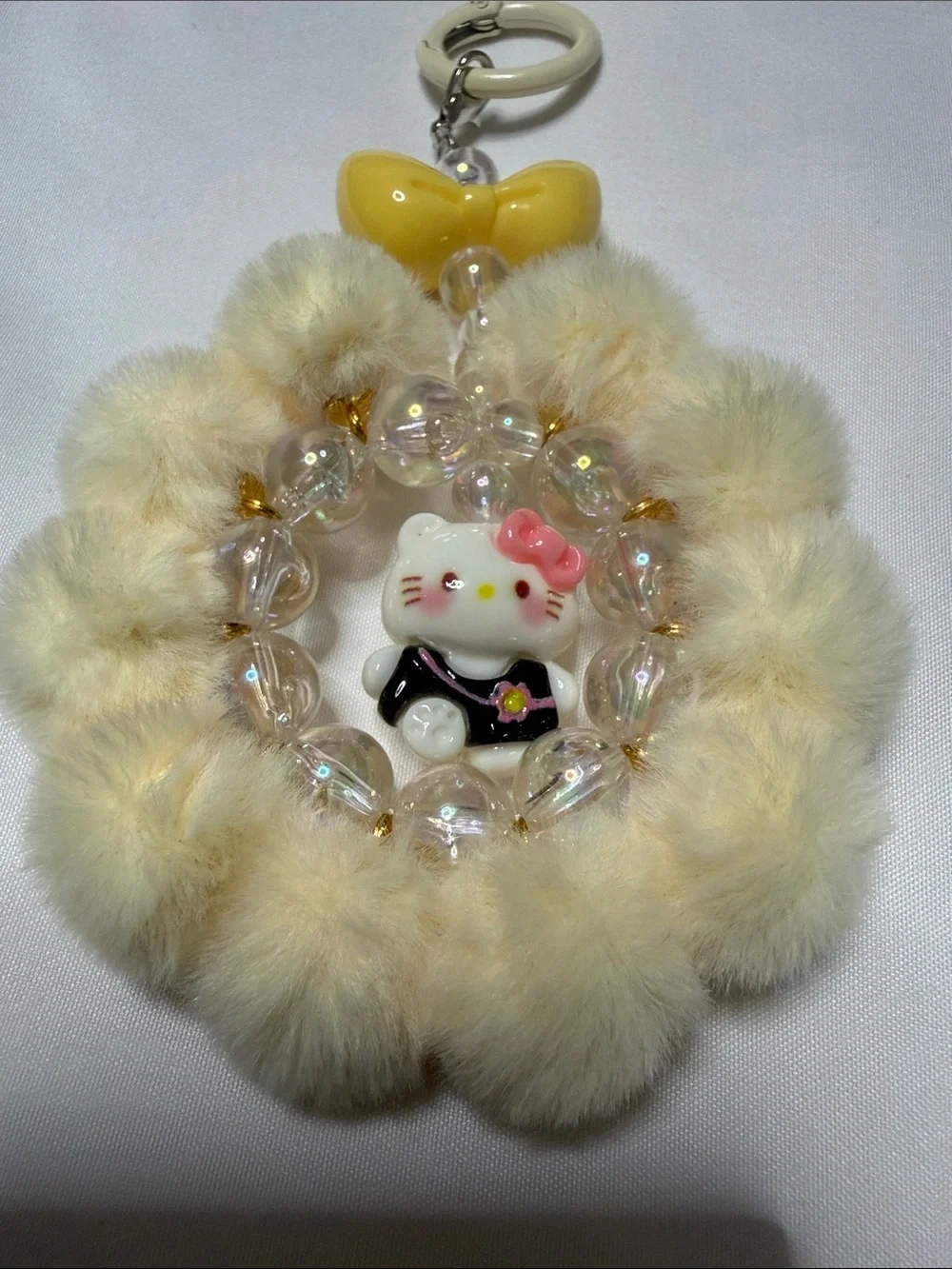 Hello Kitty Cream Faux Fur Pom Keyring with Yellow Bow & Pink Accent