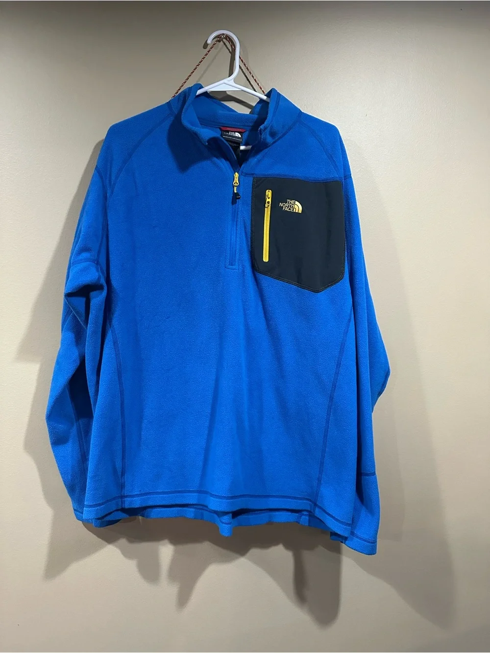 The North Face Blue Fleece Pullover with Black Chest Pocket and Yellow Zipper