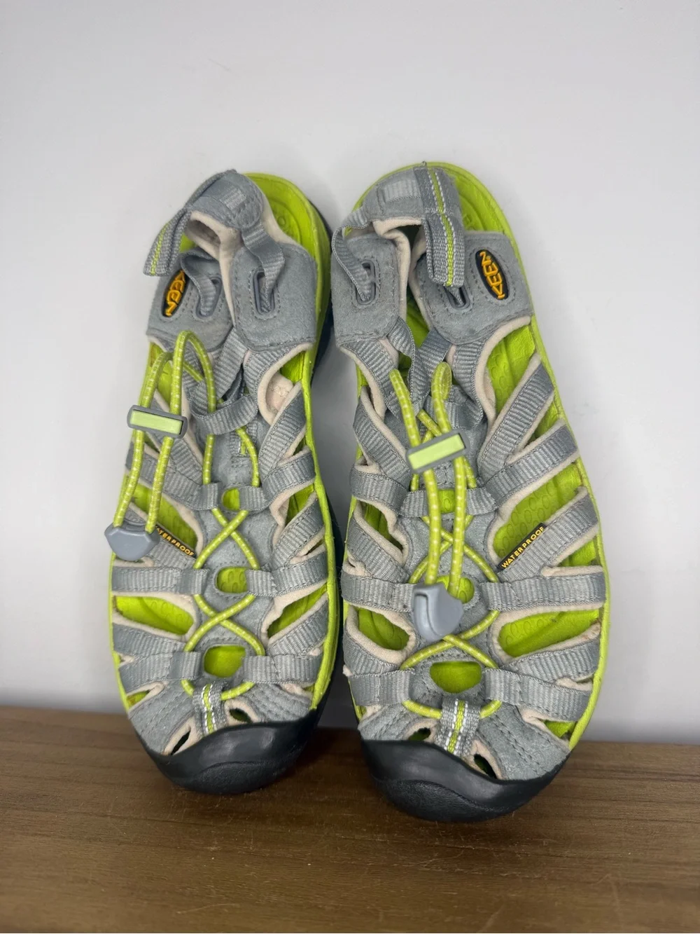 women's Keen Whisper sandals in a neutral gray and bright green colorway