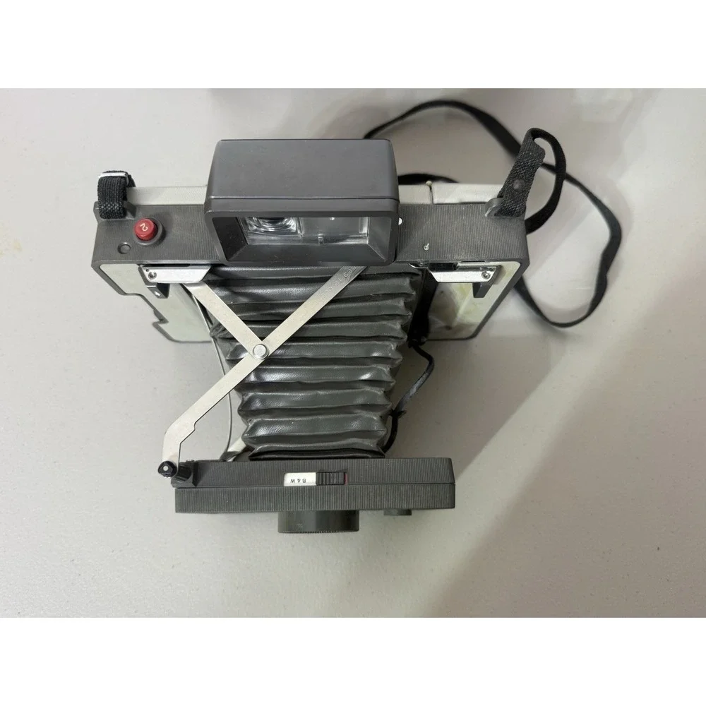 Polaroid camera extends