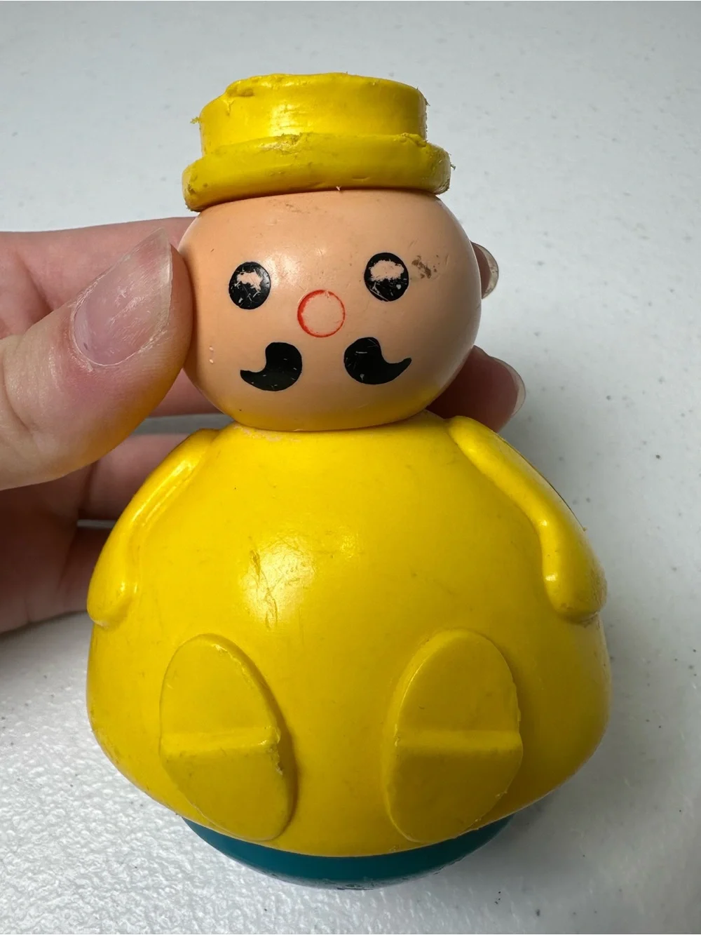Fisher-Price Yellow Roly-Body Toy with Peach Face and Blue Base