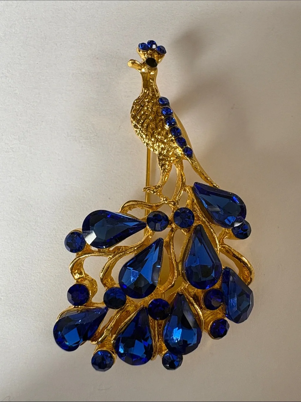 Gold Peacock Brooch with Royal Blue Crystal Accents